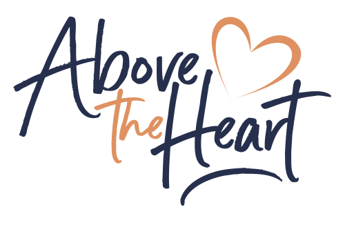 A black background with the words above the heart written in orange and blue.